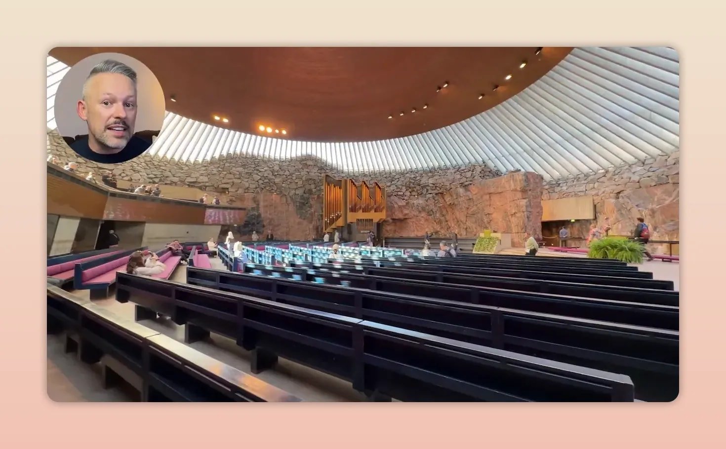 Church interior with exposed rock walls, rows of pews, and a circular ceiling